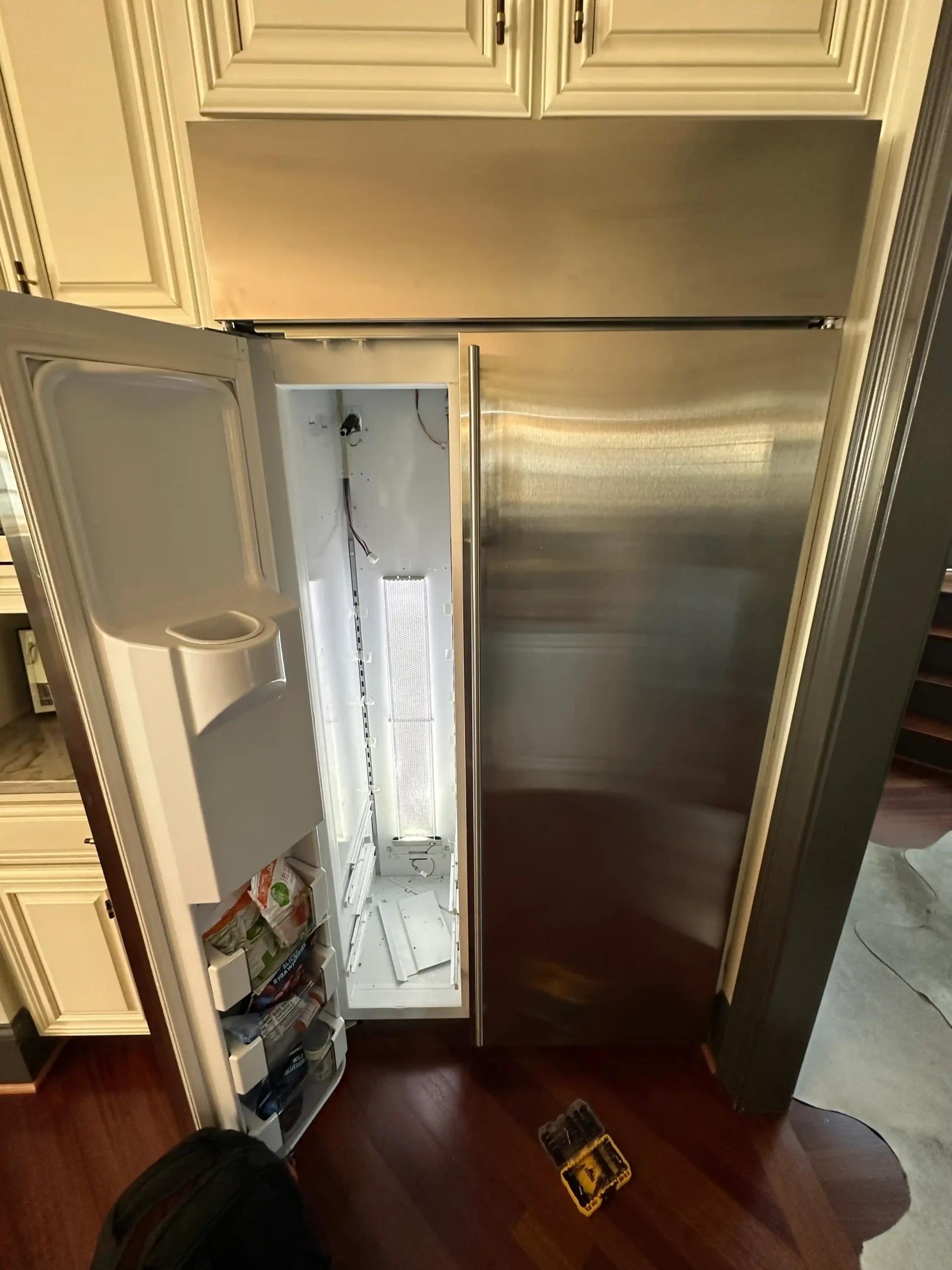 Open refrigerator door with the interior compartment exposed during a cooling-system diagnosis.